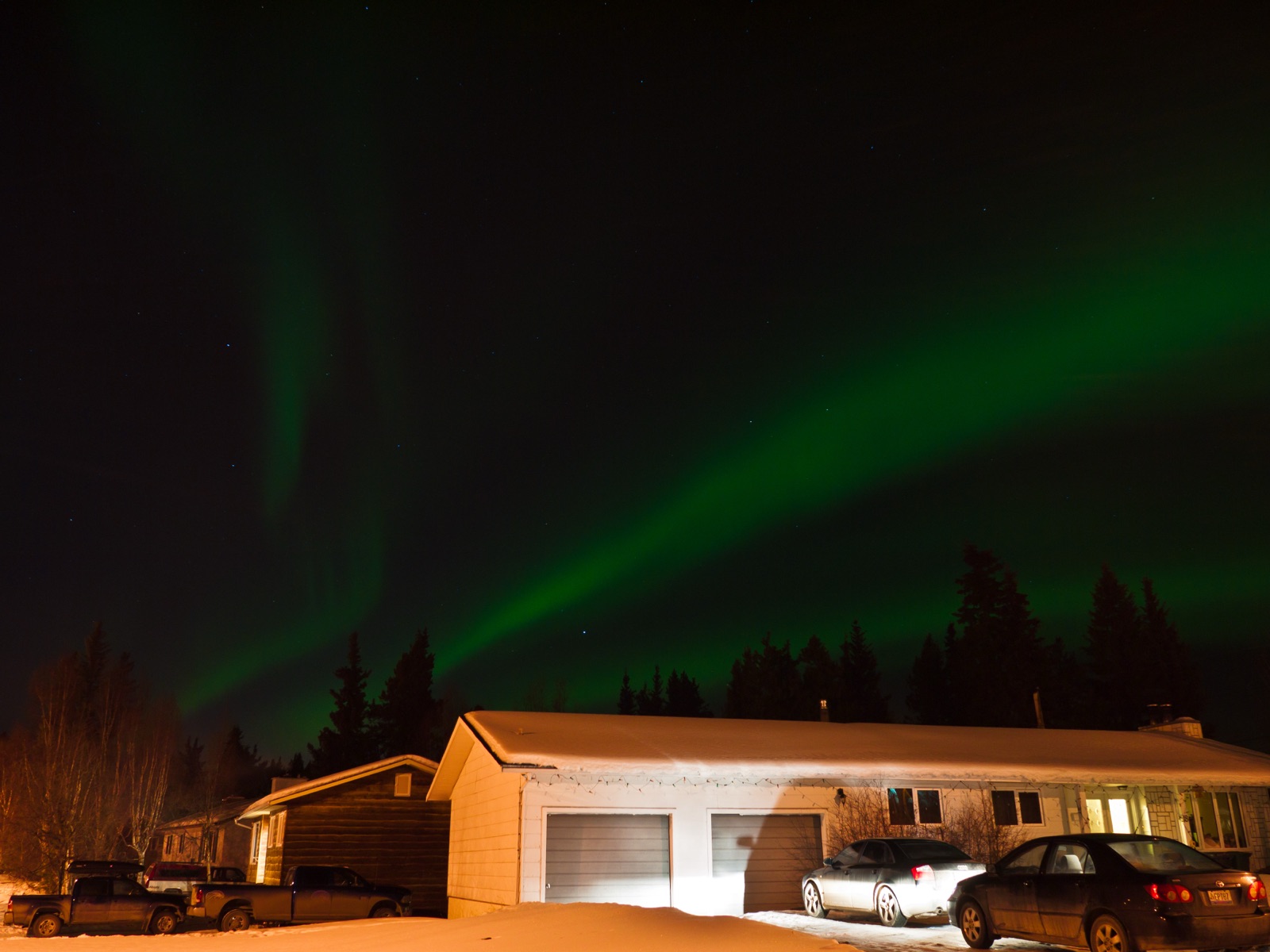 Riverdale Whitehorse with northern lights aurora over the east-bank residential grid
